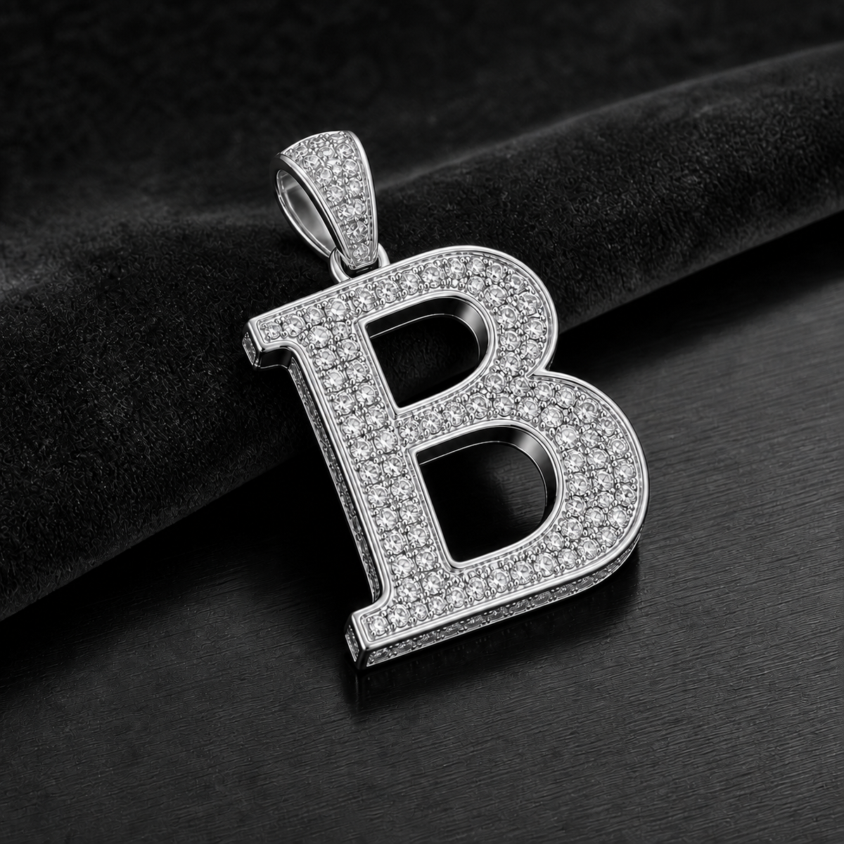 Blacknest Vault white gold or platinum initial pendant on black velvet